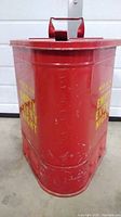 Full side view of red fireproof waste can with embossed Eagle branding and handle on top