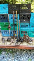 Overview of all tools and pulleys displayed on wood surface, with milk crates in background.