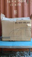 Cardboard box exterior with printed range hood illustration and text 'WALL MOUNT RANGE HOOD'