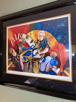 Full view of colorful abstract framed art showing musicians and signed by Marcus Glenn