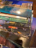 Stack of glossy postcards featuring Hawaii images and titles such as 'The Royal Hawaiian'.