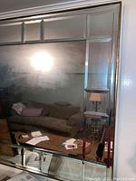 Full view of the large beveled edge mirror showing its sectional beveled panels and reflective surface.