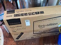 Box of Insignia Fire TV edition 32 inch LED TV showing model and features