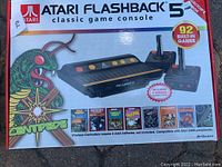 Original packaging box showing Atari Flashback 5 console with 92 built-in games and artwork for Centipede.