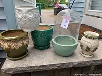 Overview of the five assorted flower pots and terrarium dome showing variety of styles and colors