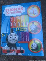Front view of sealed package of Thomas & Friends 12 board books featuring Thomas the Tank Engine characters and cover design.