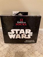 Front view of the sealed box packaging for Star Wars 12 Days of Socks, featuring the Star Wars logo and mention of women's shoe sizes 4-10.