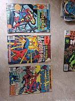 Photo showing three Marvel Tales Spider-Man comic books and one The Incredible Hulk comic book with colorful action covers