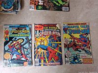 Front covers of three Marvel comic books featuring Spider-Man with Captain Britain, The Spectacular Spider-Man, and Marvel Tales Spider-Man