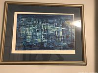 Front view of abstract blue print with silver frame and dark blue mat.