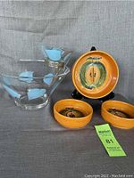 Photo of Anchor Hocking chip and dip set with turquoise floral design and three orange Israel ceramic apple dishes on gray background.