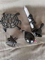 Photo of all four cast iron items on fabric surface