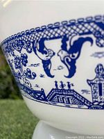 Close-up of Blue Willow pattern on the Federal Glass mixing bowl, showing detailed blue design on white glass.