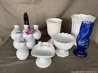 Lot of six decorative vases and soap dish arranged on fabric background