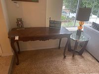 Full view of wood console table against wall, showing size and shape