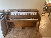 Full frontal view of upright Story & Clark piano including keyboard and upper panel, showing overall design and style