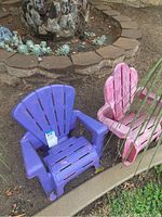 Purple and pink plastic outdoor child chairs next to garden area showing condition and color.