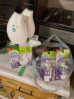Four Air Wick Freshmatic Mini automatic spray units: two loose and two in boxes. Ten refill cartridges in Lavender Fields scent displayed in plastic packaging.