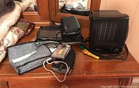 Photo of all items together including the Honeywell heater, TomTom GPS with accessories, Kodak camera, and related cases and cords.