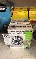 Photo showing one boxed O2 Cool portable battery operated fan with product packaging and tag visible.