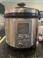 Front view of Breville BPR700 pressure and slow cooker showing digital display, three knobs and start/stop buttons