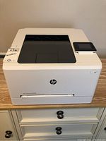 Front and top view of printer on wooden surface