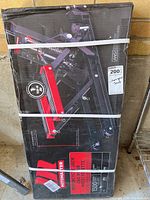 Photo of boxed Motomaster motorcycle jack with visible branding, graphics, and product information on the box.