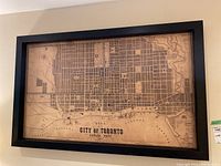 Front view of framed lithograph map on wall