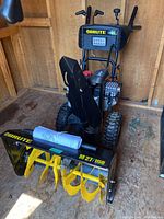 Full front view of snowblower showing chute, auger housing, engine and controls