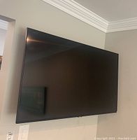 Front view of mounted TV showing screen and bezel