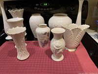 Front view of the vases arranged showing shapes and embossed floral details