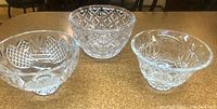 Three crystal bowls displayed side by side on countertop, showing overall shapes and patterns