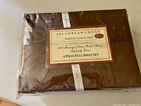 Original packaging of a brown sheet set showing 400 thread count and Majestic Collection branding.