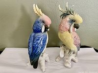 Front view of both cockatoo figurines side by side