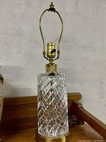 Front view of the Waterford crystal cylinder lamp showing the cut swirl design and brass fittings.