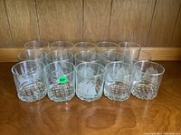Photo showing all 15 vintage etched lowball glasses arranged in front view.