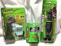 Full lot of 3 new Primos hunting calls in packaging: Mouth Call Howler Pak, The Great Big Can, and Bottleneck Deer Grunt