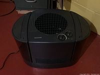 Full view of black Honeywell dehumidifier with top fan vent and control panel.