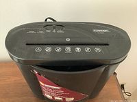 Front and top view of the black ID Armor ID-C505PZ electric paper shredder showing control panel, paper slot, and shredding capacity icons.