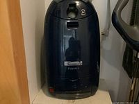 Kenmore Elegance canister vacuum cleaner in dark blue with handle and controls visible at top.