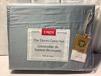 Front packaging showing Endy brand, product as duvet cover set, queen size, 300 thread count, 100% organic cotton in Glacier Blue color