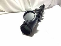 Front angled view of the Excalibur crossbow scope showing lens cover and zoom tube.