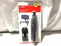 Front view of Joby GripTight ONE GP Stand retail packaging showing black GorillaPod flexible tripod and separate GripTight smartphone holder attachment visible through plastic blister pack