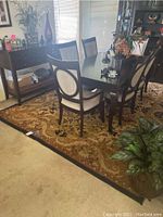 Anatolia floor rug under dining set with dark wood table and chairs, showing overall pattern and color