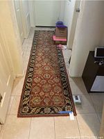 Full view of the rectangular wool floor runner in a hallway showing the complete design and size