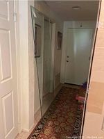 Full view of the large glass panel standing vertically in hallway, showing its size and transparency.