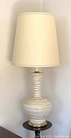 Full view of the large vintage Mid-Century Modern style Fat Lava ceramic table lamp with cream fabric shade, showing overall appearance and details.