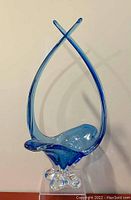 Front view of blue stretch art glass bowl showing curved design and clear base
