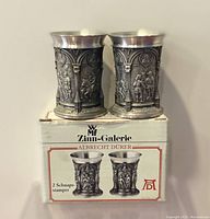 Pair of pewter schnapsstamper photographed with original box showing design and branding