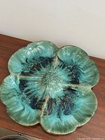 Top view of the floral-shaped pottery serving dish showing color and glazing details.